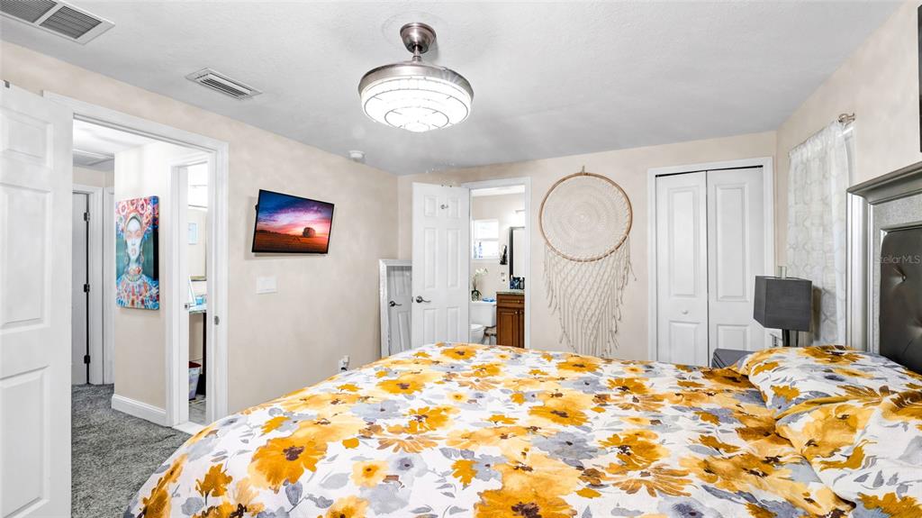 500 Hillpine Way Brandon, FL 33510 - Photo 19 of 39 a bedroom with a bed and a chandelier