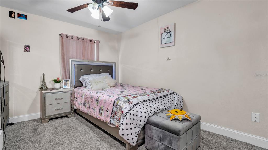 500 Hillpine Way Brandon, FL 33510 - Photo 24 of 39 a bedroom with a bed and a chandelier