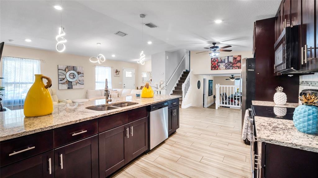 500 Hillpine Way Brandon, FL 33510 - Photo 7 of 39 a kitchen with stainless steel appliances granite countertop a sink counter space and wooden floor