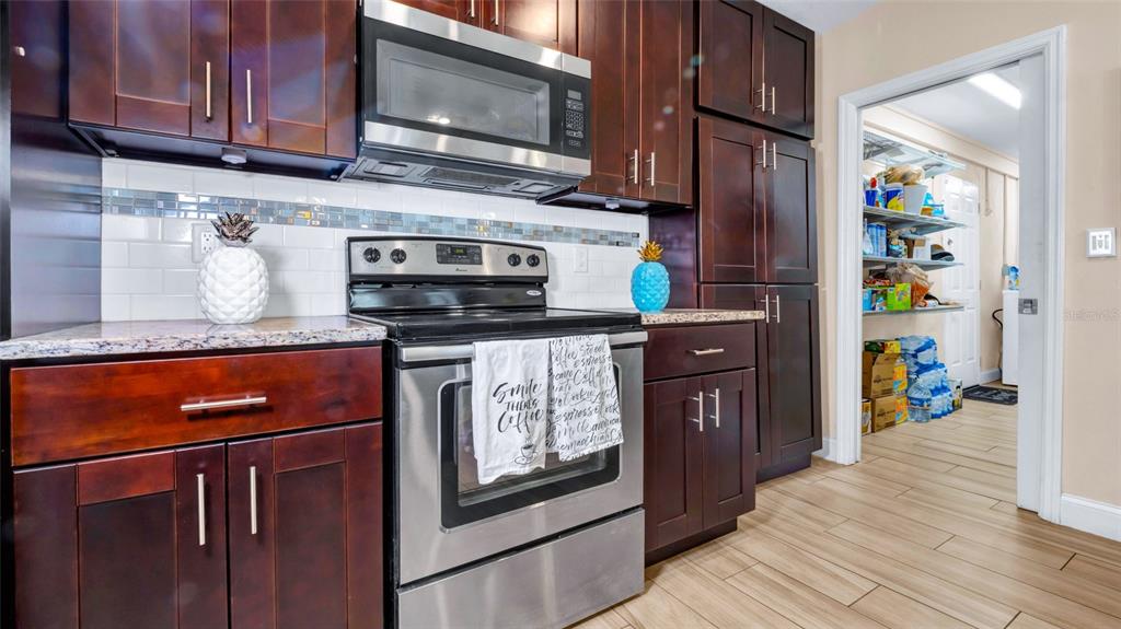 500 Hillpine Way Brandon, FL 33510 - Photo 9 of 39 a kitchen with stainless steel appliances granite countertop a refrigerator stove and microwave