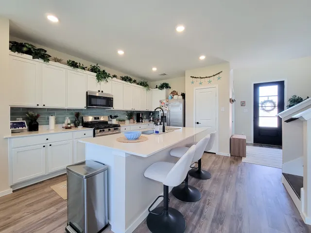 a kitchen with sink a stove and cabinets