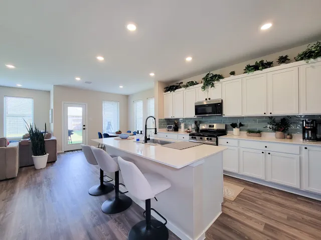 a kitchen with a sink stove and refrigerator