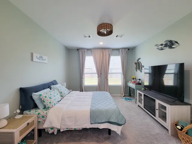 a bedroom with a bed and a window