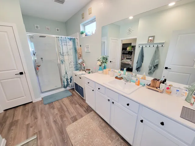 a bathroom with a sink mirror toilet and shower