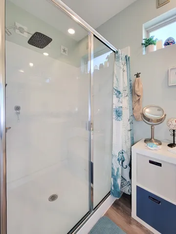 a hallway with furniture and wooden floor