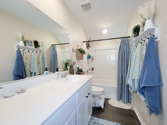 a spacious bathroom with a double vanity sink and a mirror