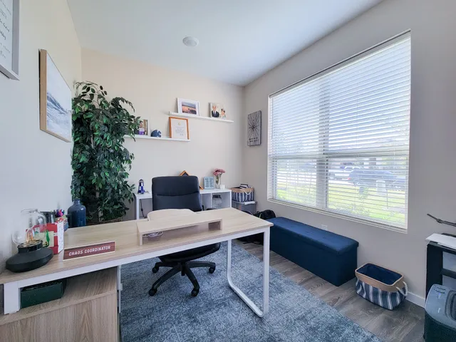 a workspace with furniture and chandelier