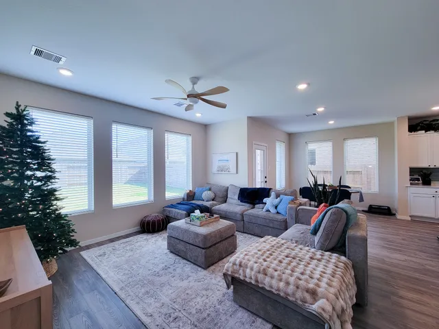 a living room with furniture potted plant and a window