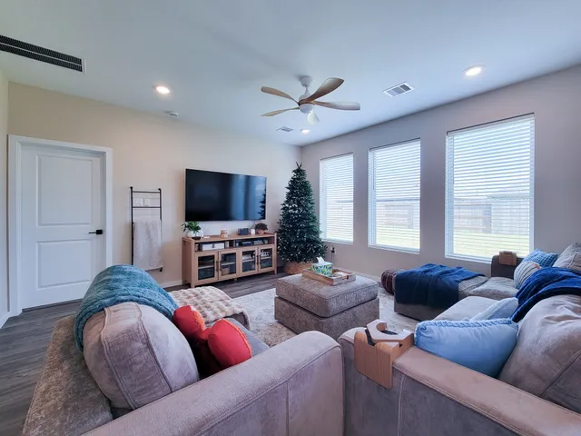 a kitchen with stainless steel appliances kitchen island granite countertop a table chairs sink and cabinets