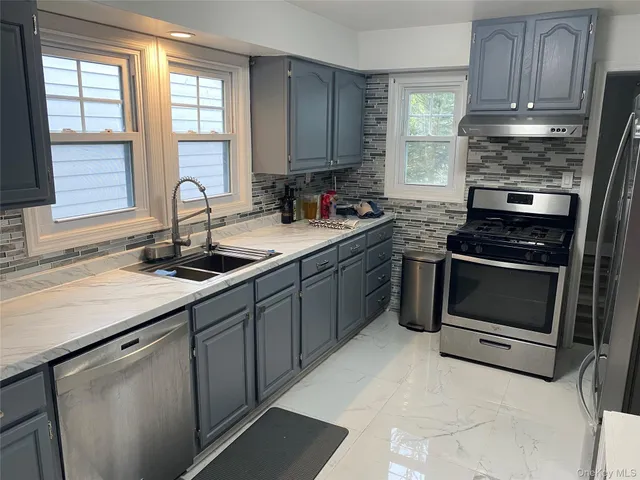 a kitchen with a sink stove and cabinets