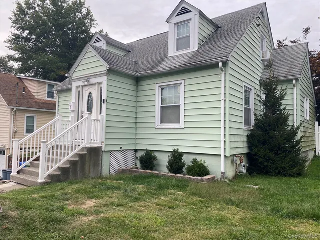 a view of a house with a yard and a garden