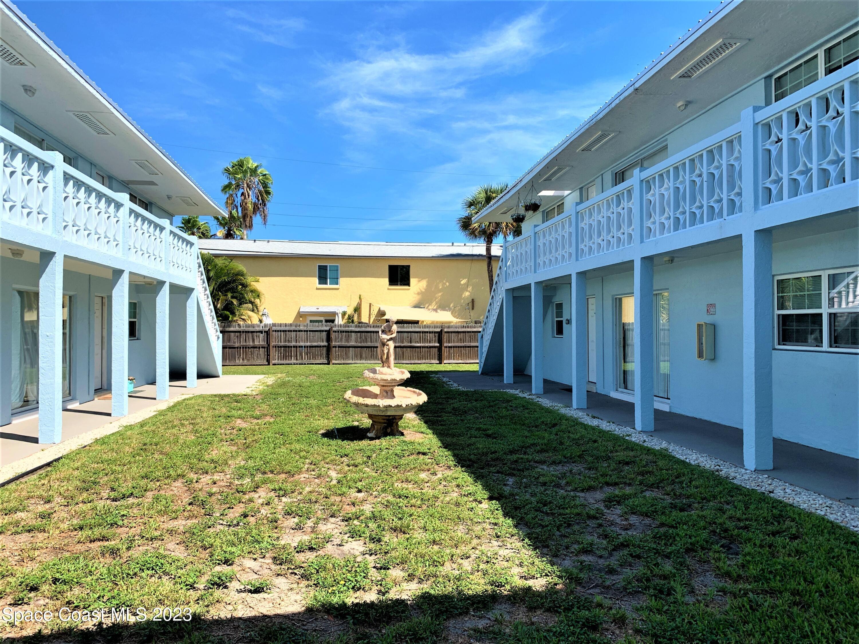 304 Buchanan Avenue, Unit 2 Cape Canaveral, FL 32920 - Photo 2 of 7 a view of a backyard with plants and patio