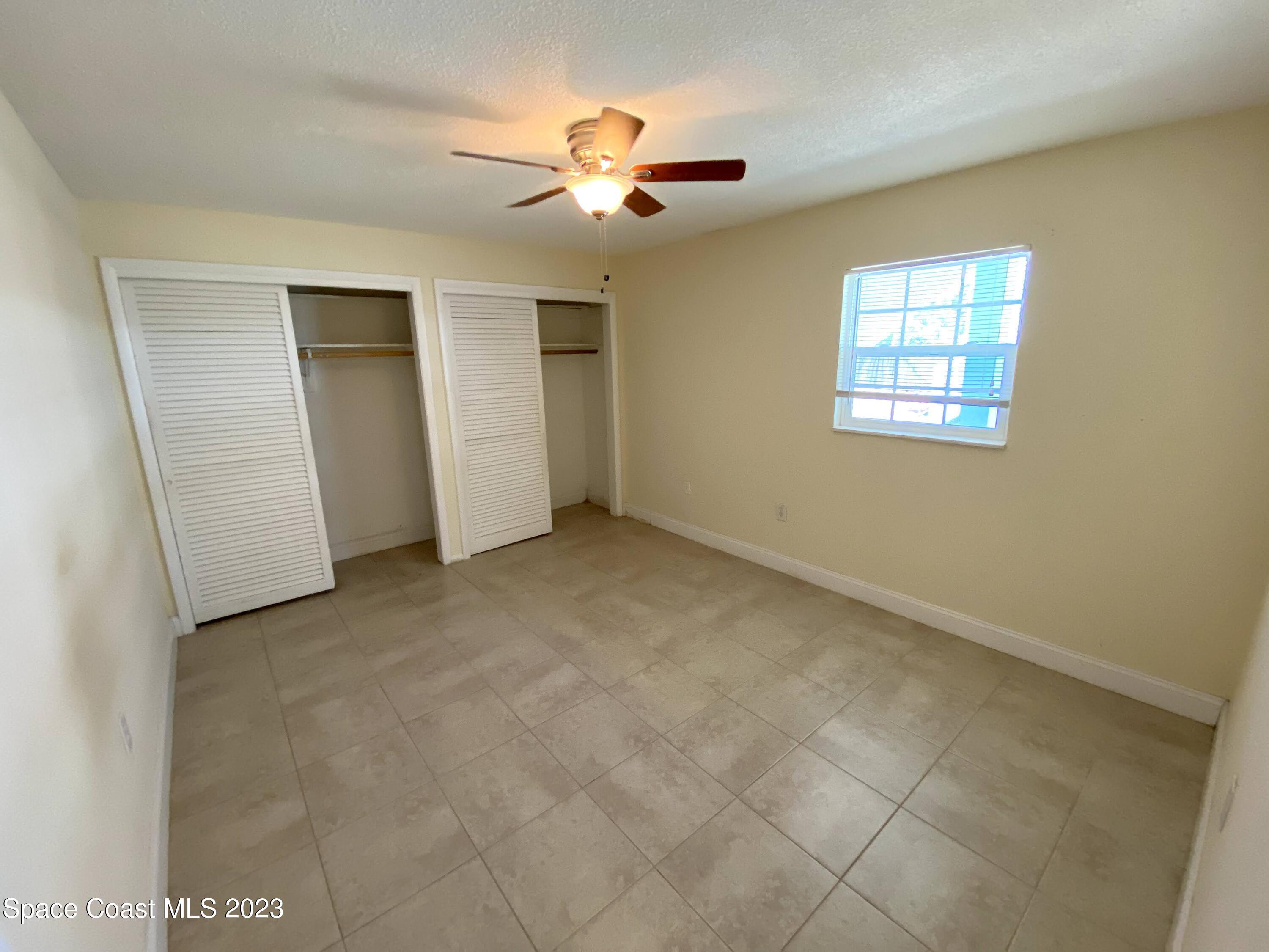 304 Buchanan Avenue, Unit 2 Cape Canaveral, FL 32920 - Photo 5 of 7 an empty room with closet and a ceiling fan