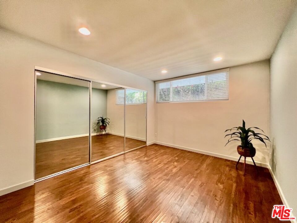 1920 Hillcrest Road, Unit 8 Los Angeles, CA 90068 - Photo 12 of 18 wooden floor in an empty room with a window