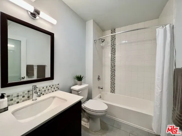 a bathroom with a sink toilet tub and shower