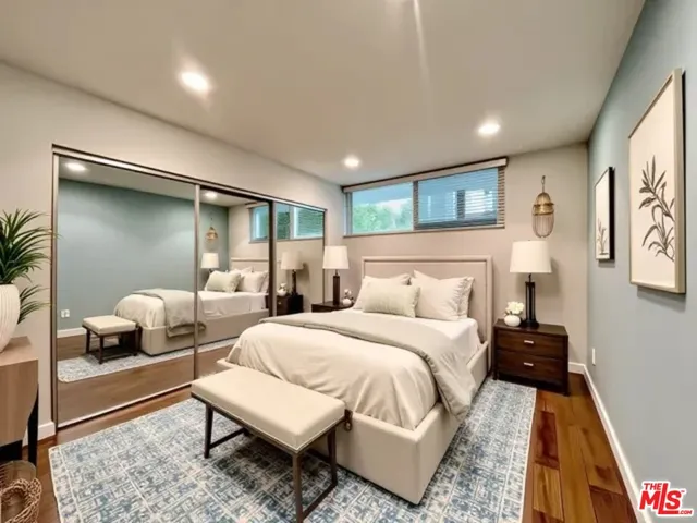 a bedroom with a bed and a couch