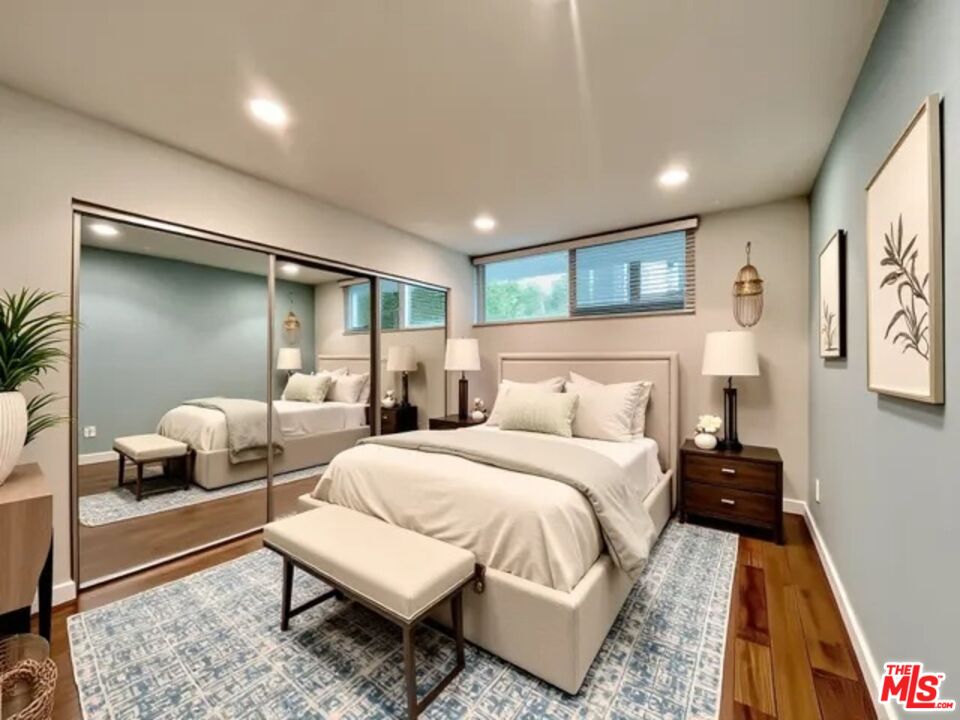 1920 Hillcrest Road, Unit 8 Los Angeles, CA 90068 - Photo 2 of 18 a bedroom with a bed and a couch