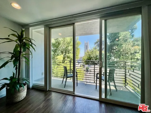 a view of a room with wooden floor and a potted plant