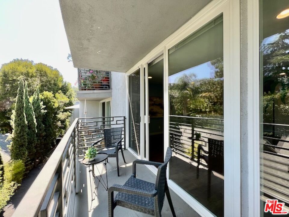 1920 Hillcrest Road, Unit 8 Los Angeles, CA 90068 - Photo 5 of 18 a balcony view with a couple of chairs