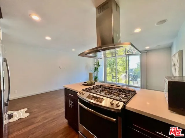 a stove top oven sitting inside of a kitchen