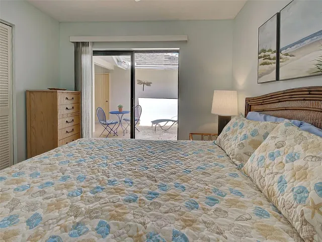 a view of a park with potted plants and large trees