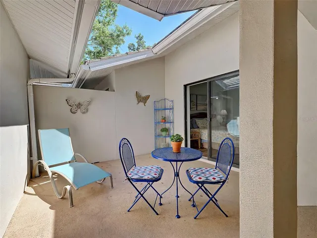 a view of house with a yard and sitting area