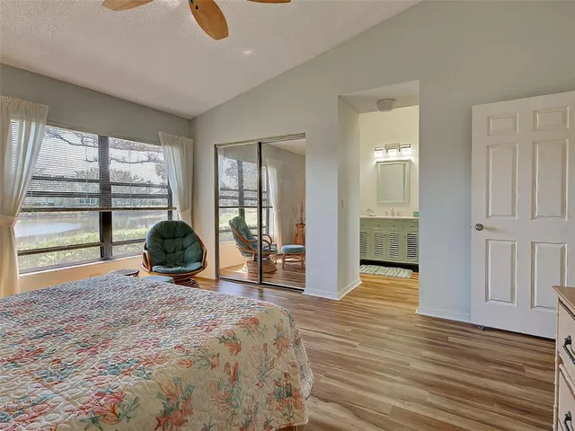 a living room with furniture a piano and a bookshelf