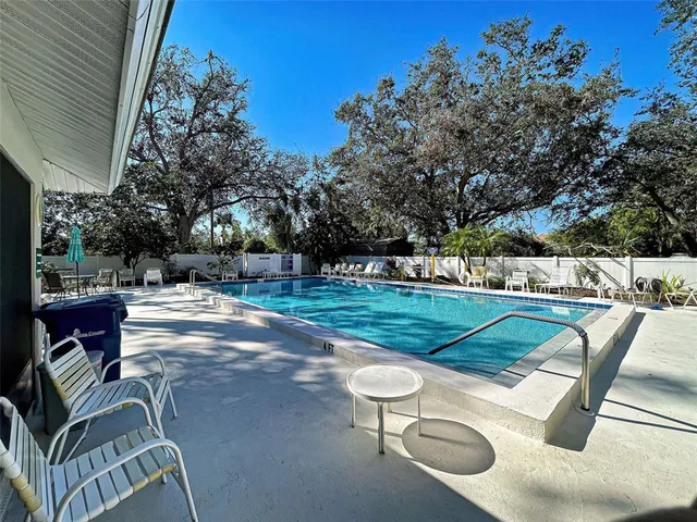 an aerial view of a house with swimming pool patio and outdoor seating