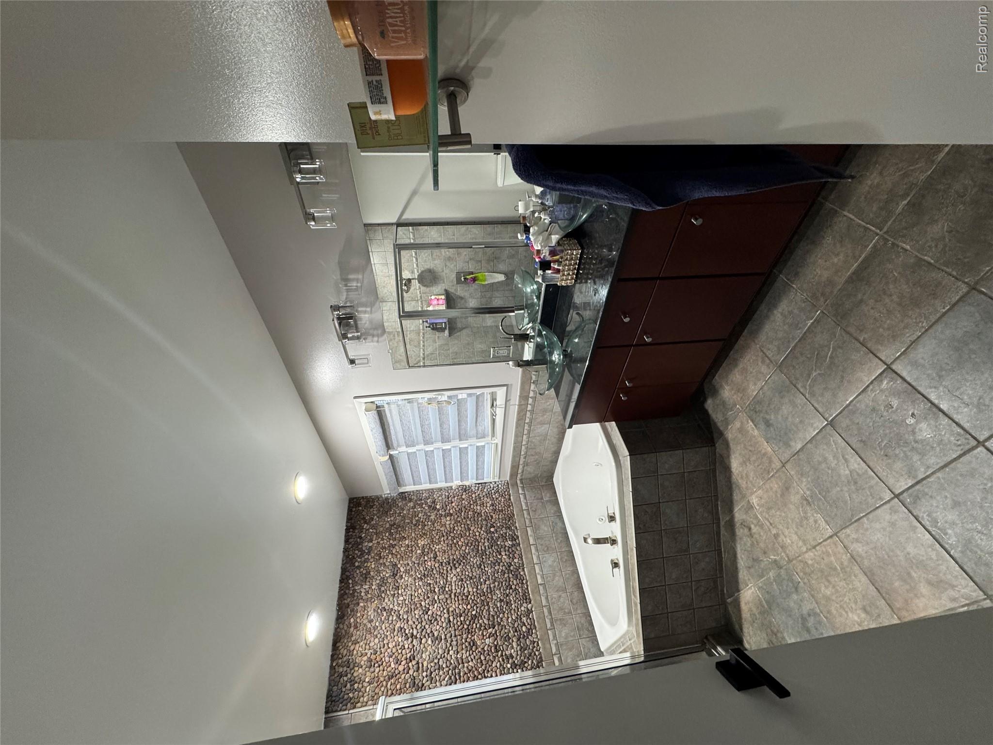 50493 Nesting Ridge Drive Macomb, MI 48044 - Photo 15 of 34 Bathroom with vanity, a garden tub, and a shower stall