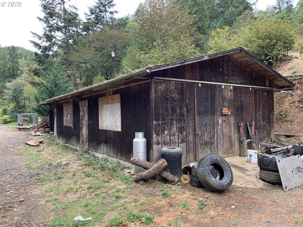 9995 Upper Olalla Road Winston, OR 97496 - Photo 28 of 29 a backyard of a house with barbeque oven and outdoor seating
