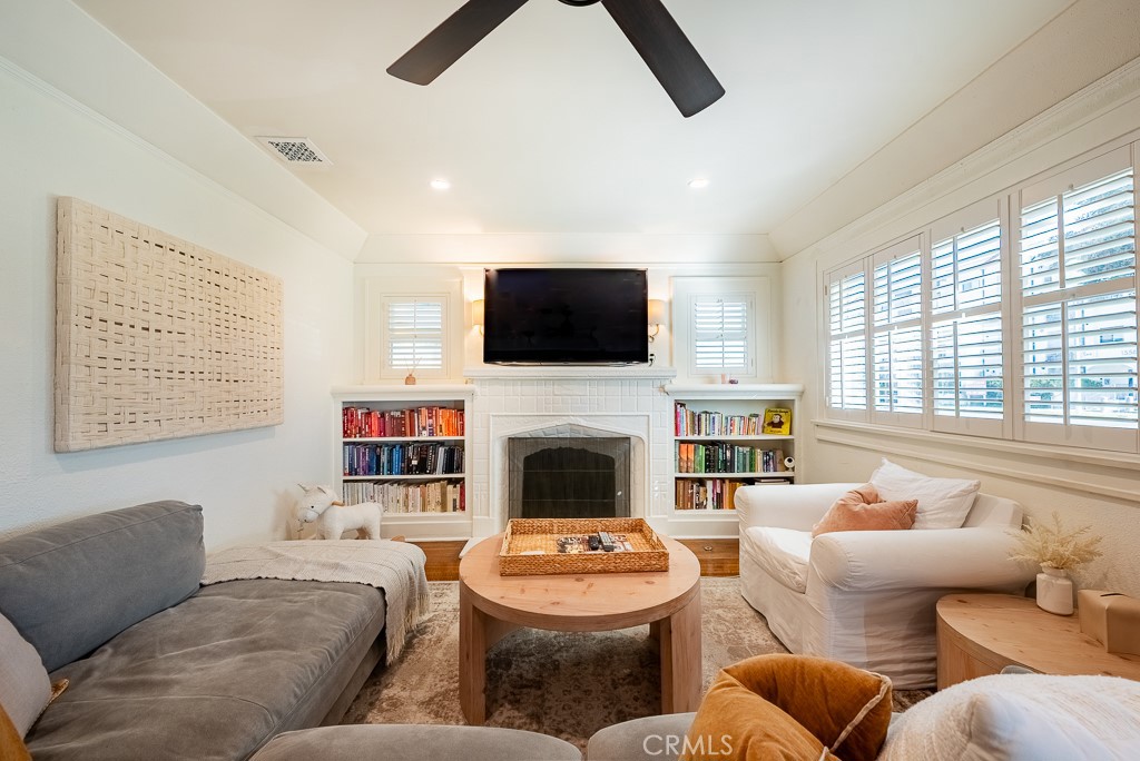 1601 Hi Point Street Los Angeles, CA 90035 - Photo 6 of 24 a living room with furniture a fireplace and a flat screen tv