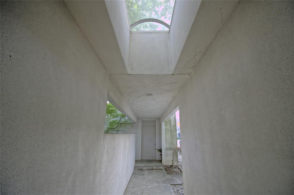 a view of a hallway to a window