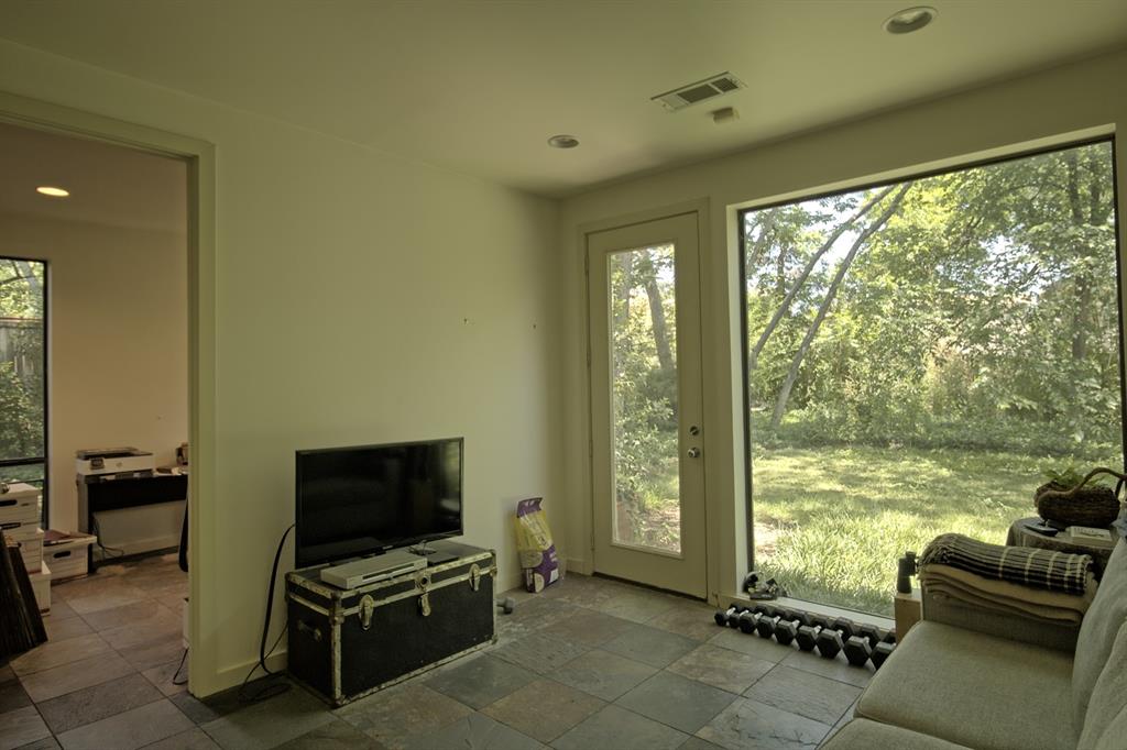 5108 Maple Springs Boulevard Dallas, TX 75235 - Photo 19 of 39 a living room with furniture and a flat screen tv