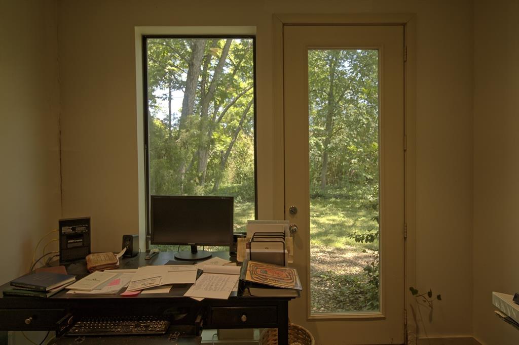 5108 Maple Springs Boulevard Dallas, TX 75235 - Photo 21 of 39 a desktop computer sitting on top of a desk with a large window and view