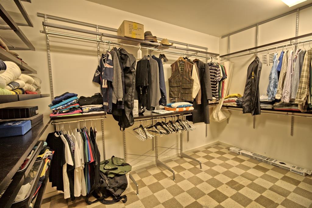 5108 Maple Springs Boulevard Dallas, TX 75235 - Photo 25 of 39 a view of walk in closet with clothes and shoes