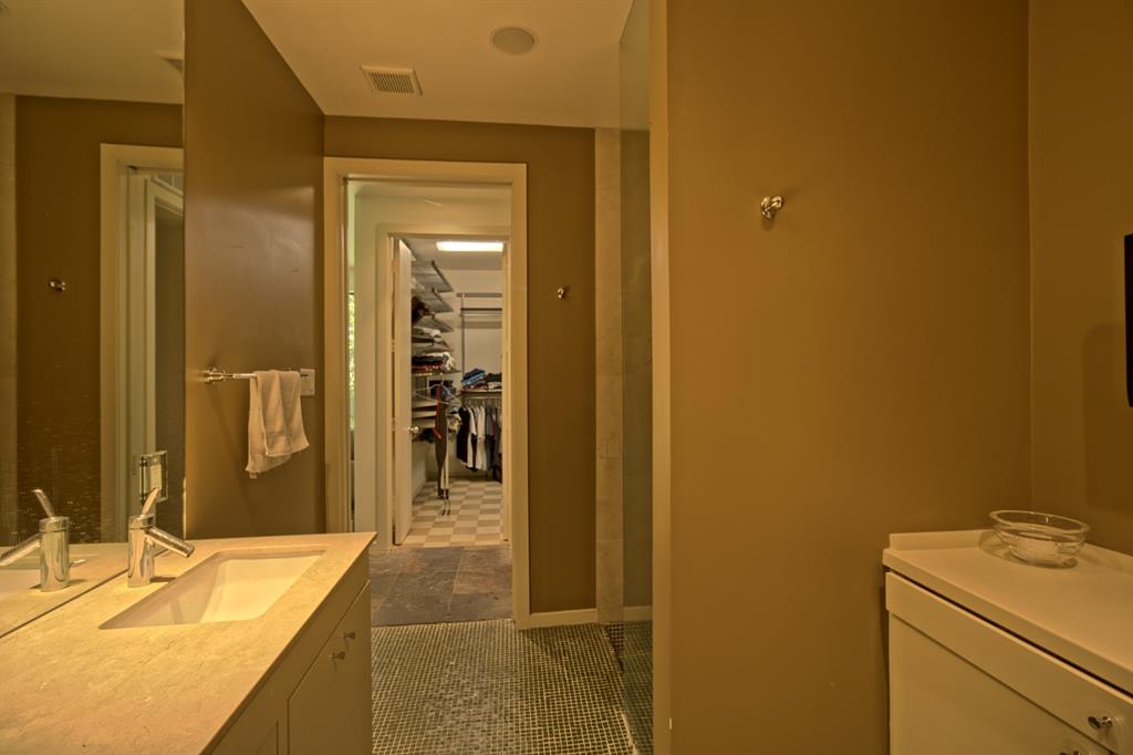 5108 Maple Springs Boulevard Dallas, TX 75235 - Photo 26 of 39 a bathroom with a granite countertop sink and a mirror