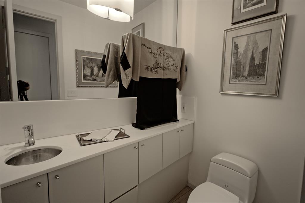 5108 Maple Springs Boulevard Dallas, TX 75235 - Photo 27 of 39 a bathroom with a toilet sink and mirror