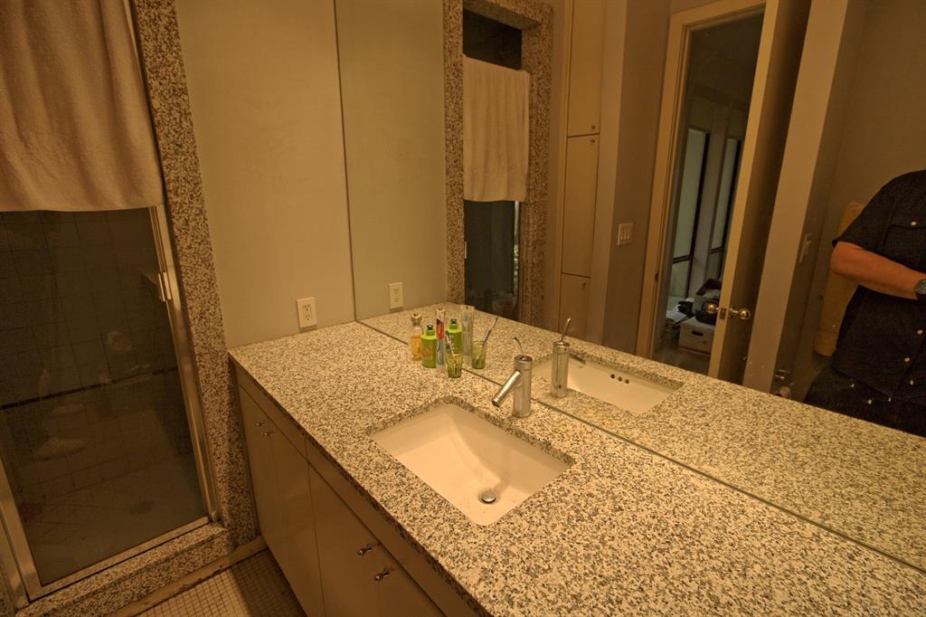 5108 Maple Springs Boulevard Dallas, TX 75235 - Photo 30 of 39 a bathroom with a granite countertop sink and a mirror