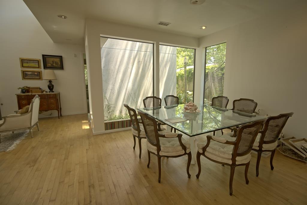 5108 Maple Springs Boulevard Dallas, TX 75235 - Photo 9 of 39 a dining room with furniture and wooden floor