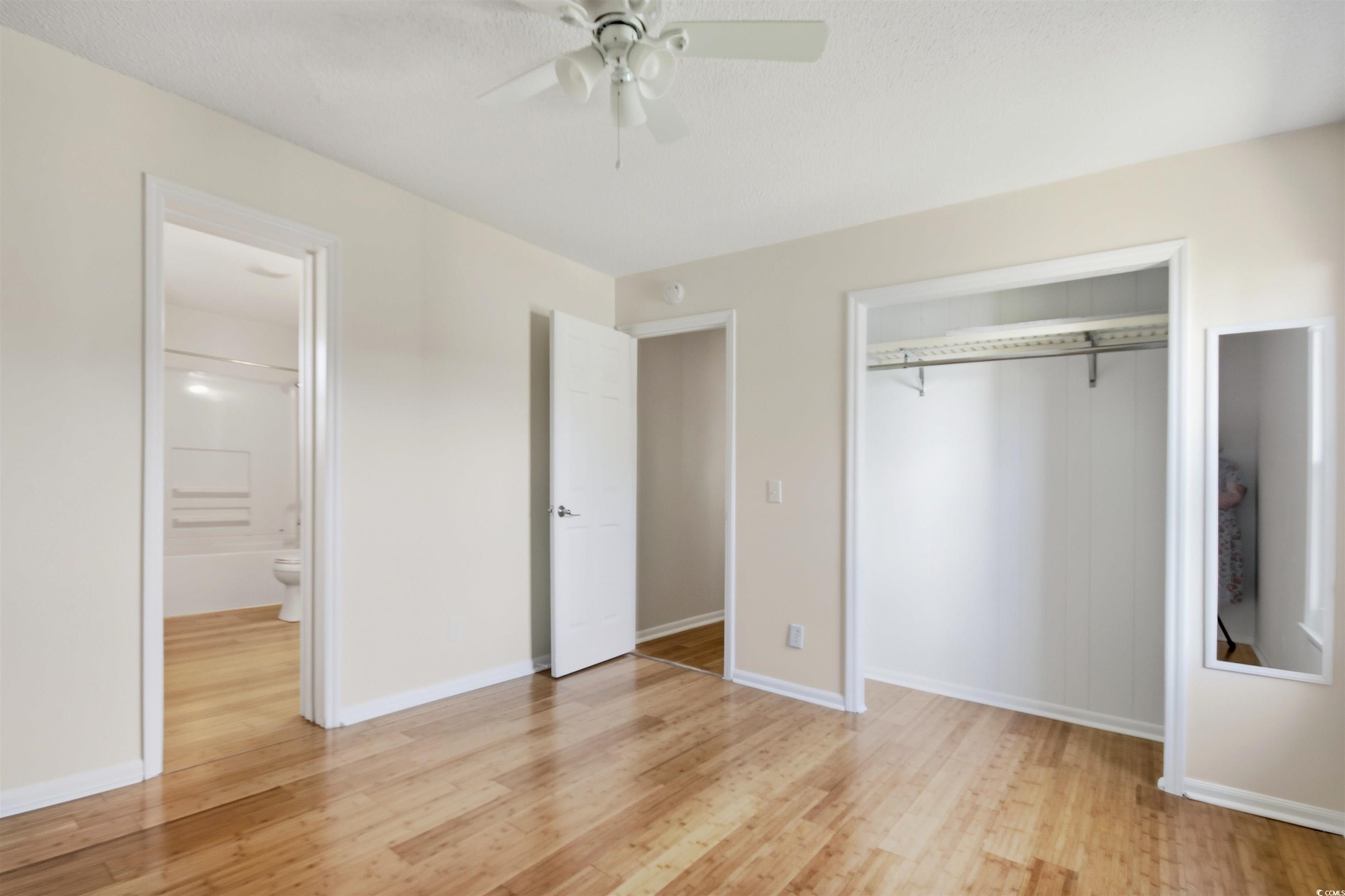 462 Bay Drive Murrells Inlet, SC 29576 - Photo 11 of 37 Unfurnished living room featuring light wood finished floors, beam ceiling, and recessed lighting