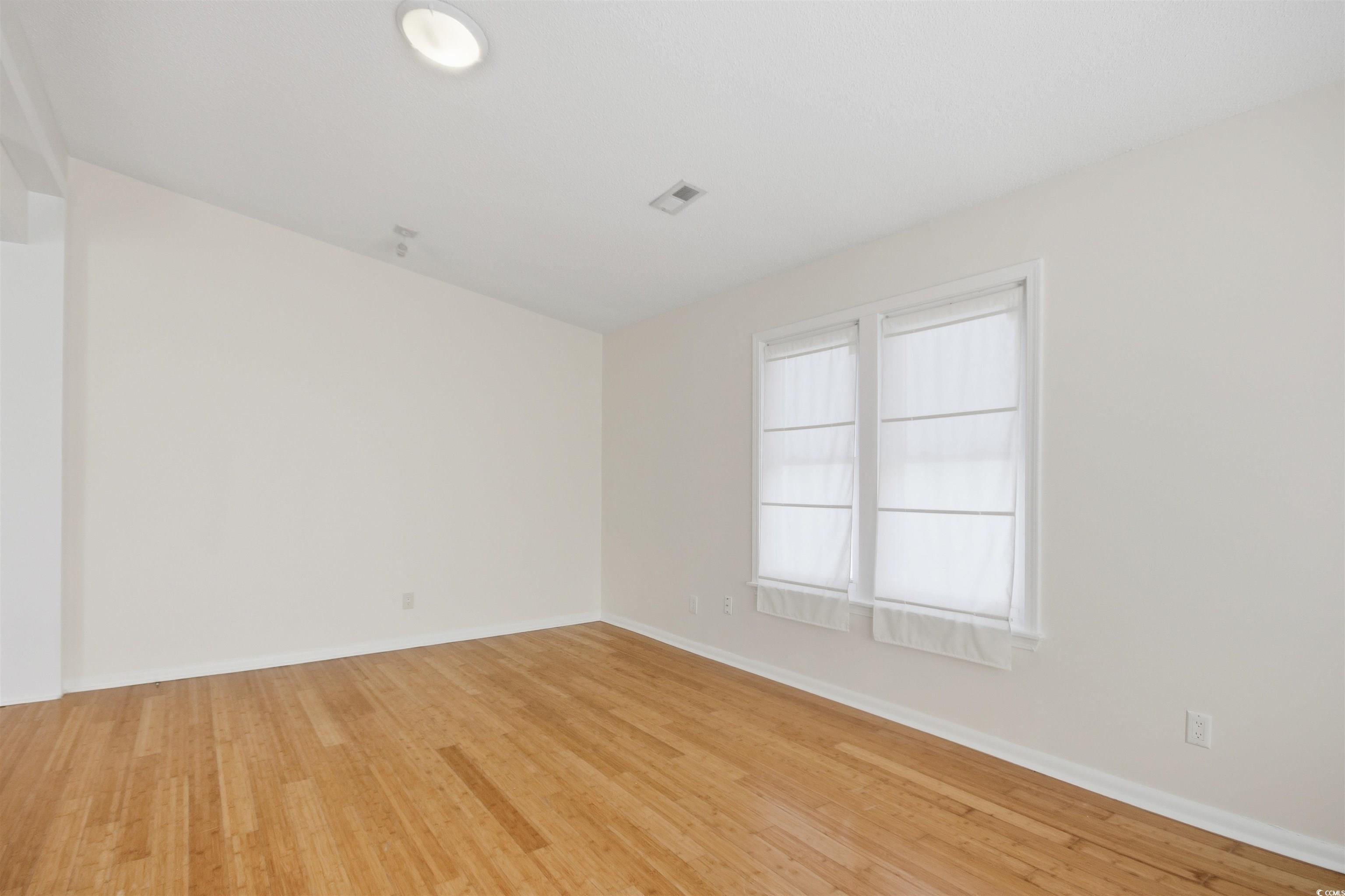 462 Bay Drive Murrells Inlet, SC 29576 - Photo 20 of 37 Empty room with light wood-type flooring and a ceiling fan