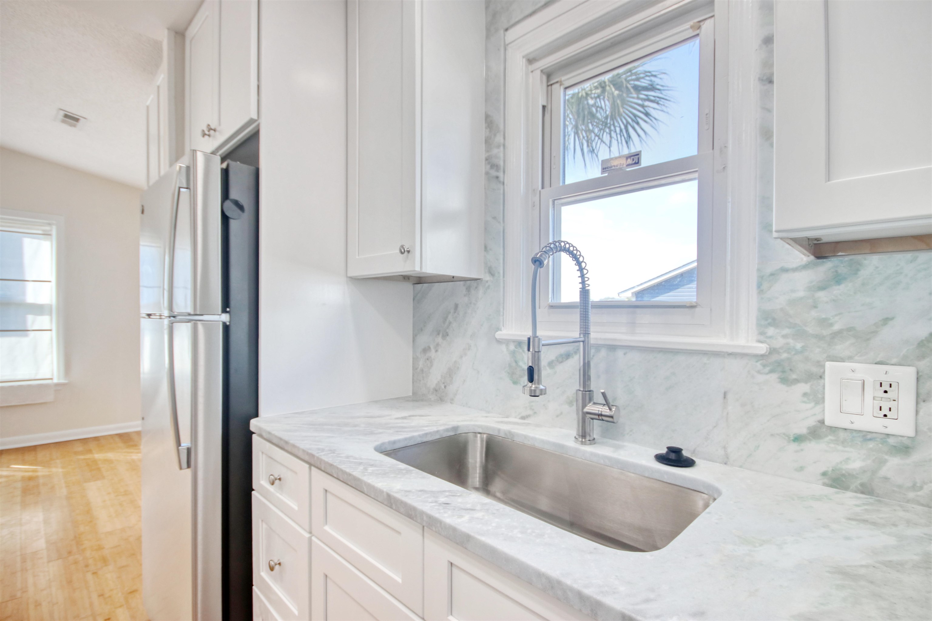 462 Bay Drive Murrells Inlet, SC 29576 - Photo 8 of 37 Kitchen with stainless steel appliances, white cabinets, light wood-style floors, decorative backsplash, and recessed lighting