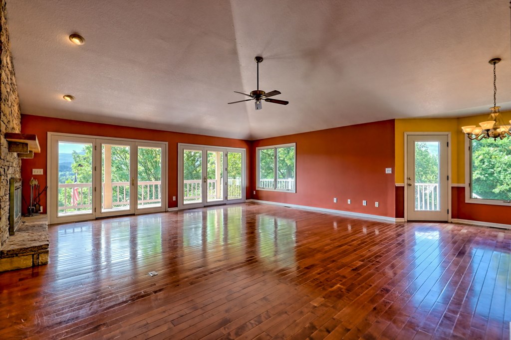 136 Elf School Road Hayesville, NC 28904 - Photo 12 of 84 a view of empty room with wooden floor and fan