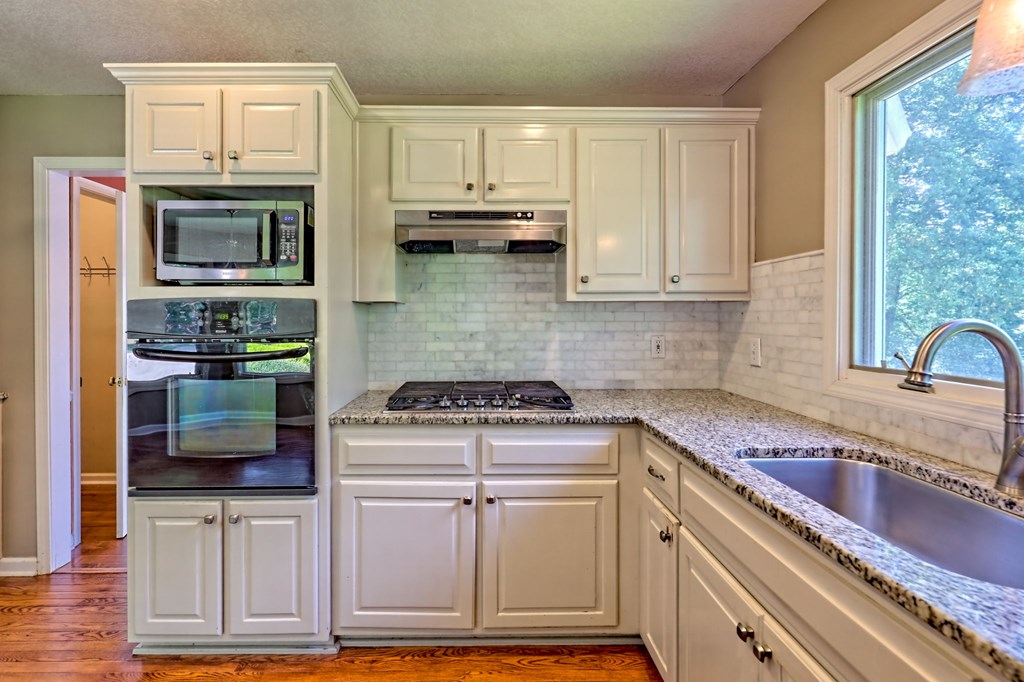 136 Elf School Road Hayesville, NC 28904 - Photo 32 of 84 a kitchen with stainless steel appliances granite countertop a stove and a refrigerator