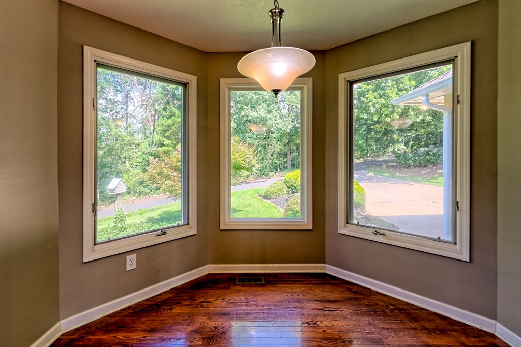 136 Elf School Road Hayesville, NC 28904 - Photo 34 of 84 a view of an empty room with wooden floor and a window