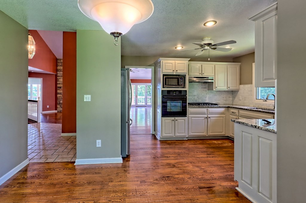 136 Elf School Road Hayesville, NC 28904 - Photo 35 of 84 a kitchen with stainless steel appliances kitchen island granite countertop a refrigerator and a stove top oven