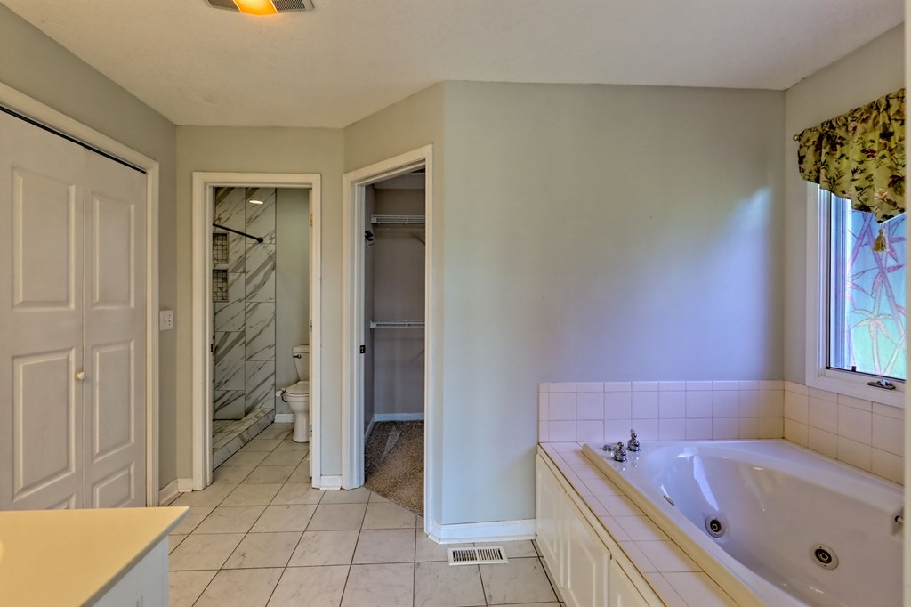 136 Elf School Road Hayesville, NC 28904 - Photo 42 of 84 a bathroom with a tub shower and a sink