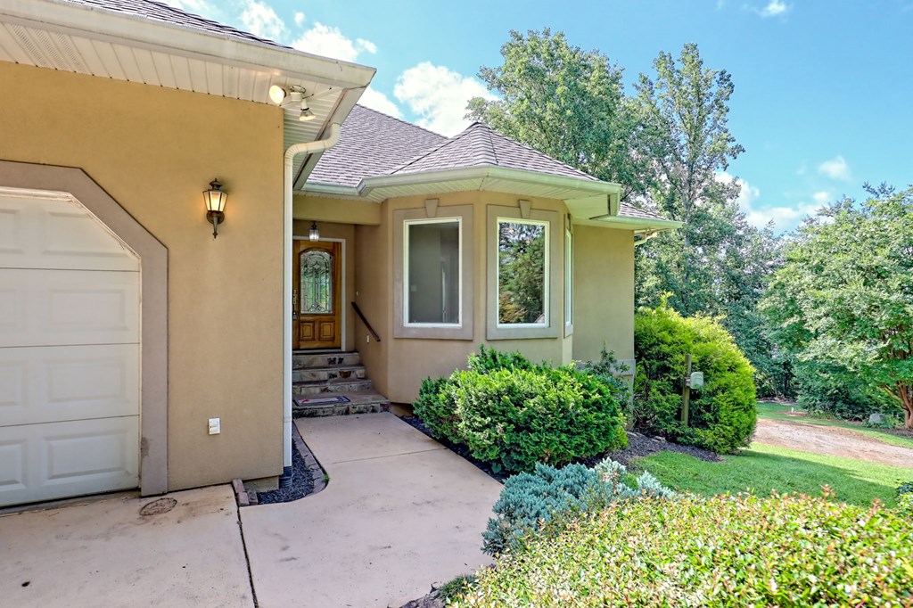 136 Elf School Road Hayesville, NC 28904 - Photo 8 of 84 a view of a house with brick walls and a yard with plants