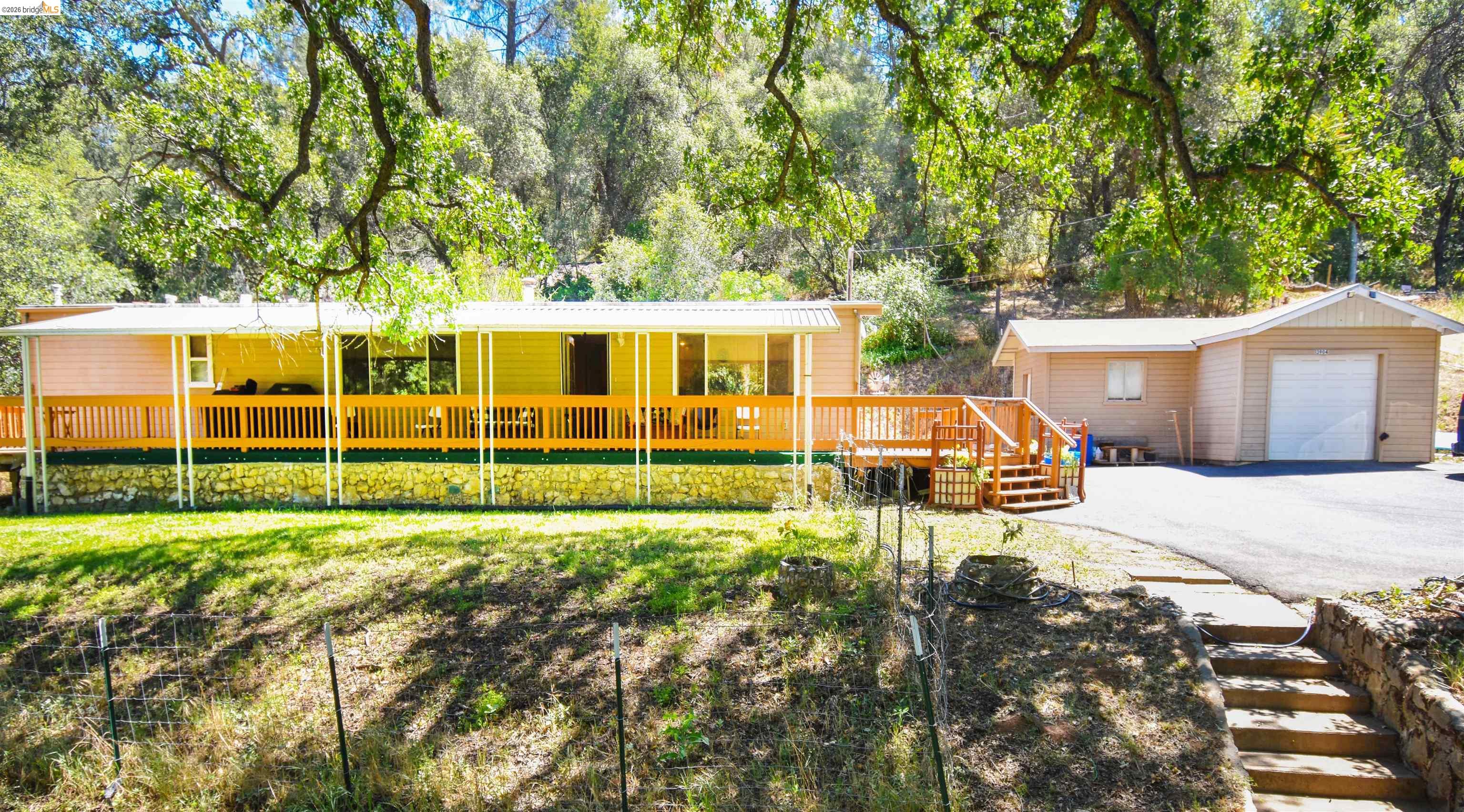13904 Tuolumne Road Sonora, CA 95370 - Photo 2 of 44 Single-story residence featuring an expansive covered porch with wood railing and support posts