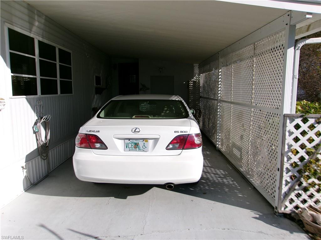 2 Monaco Terrace Naples, FL 34112 - Photo 3 of 24 View of parking featuring an attached carport